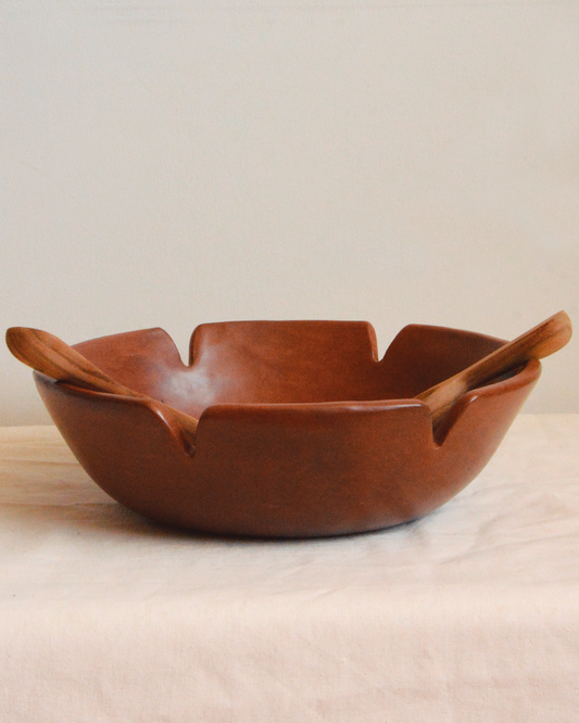 Burnished clay salad bowl and wooden spoons